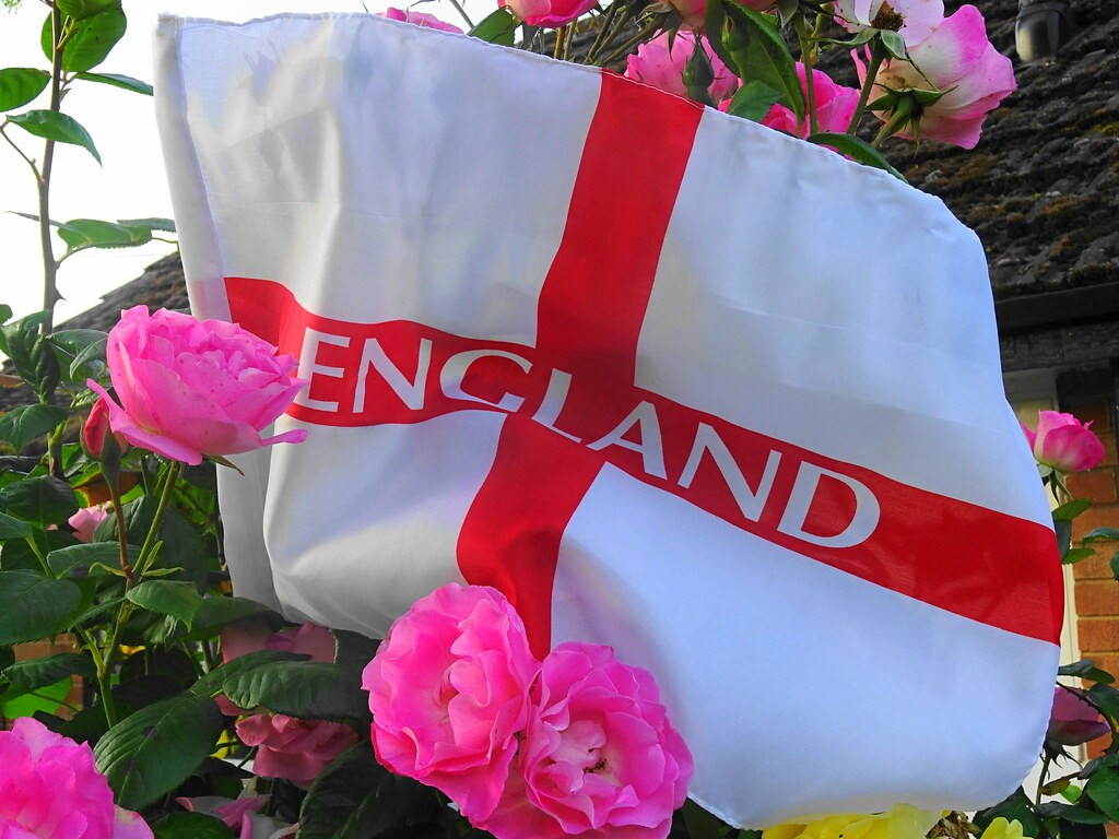 The flag of St. Geroge with the word "England" written on it surrounded by flowers