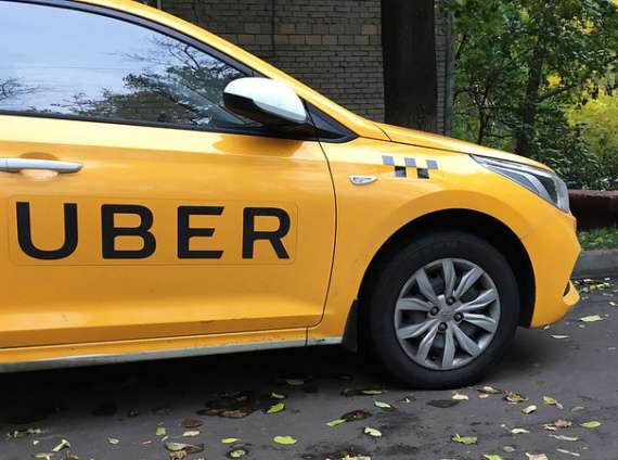 A yellow taxi with 'Uber' written on the side