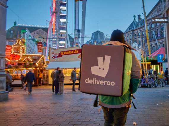 A person wearing a Deliveroo insulated backpack