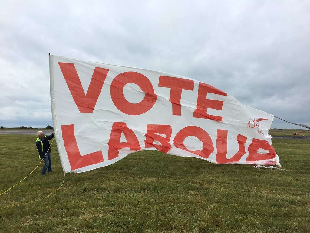 A white banner that says "Vote Labour"